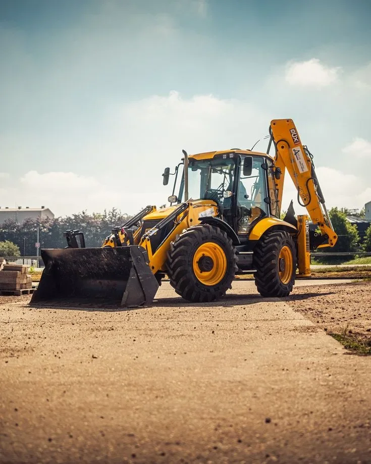 Yellow backhoe loader used for excavation, loading and site work.